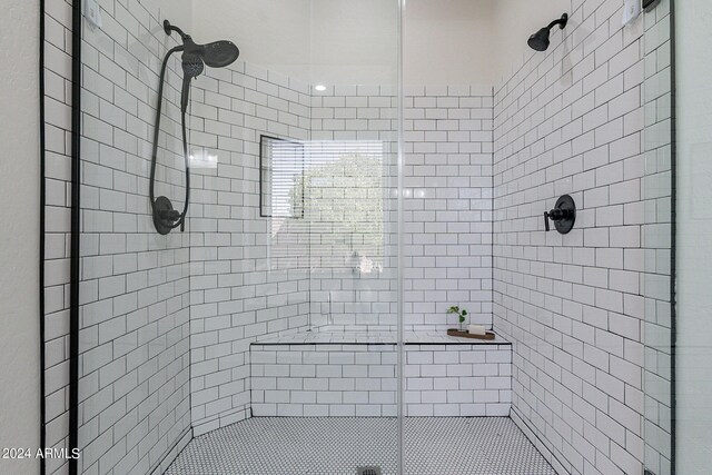 bathroom with tiled shower