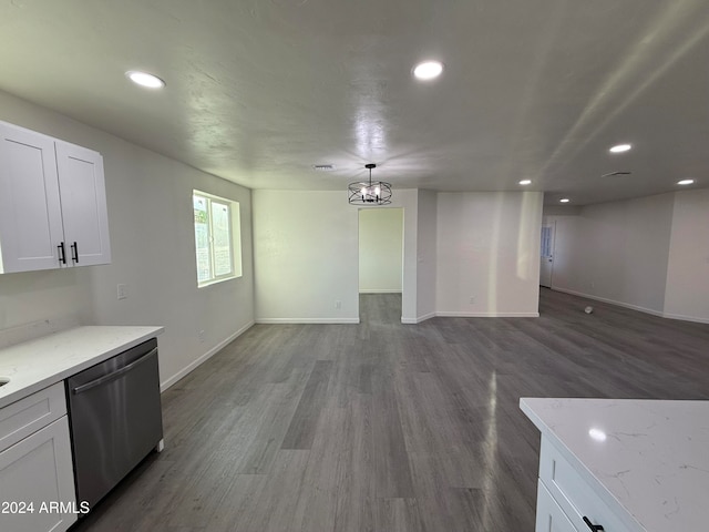 kitchen featuring wood-type flooring, light stone counters, dishwasher, hanging light fixtures, and white cabinetry