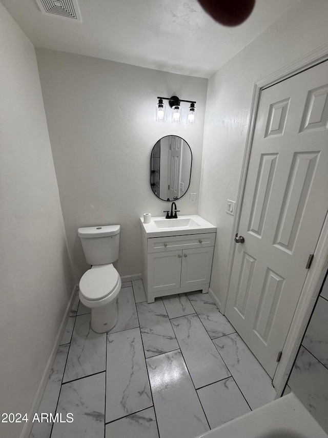 bathroom featuring vanity and toilet