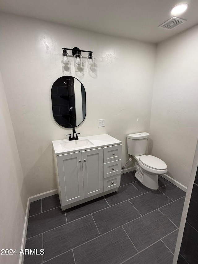 bathroom featuring toilet and vanity