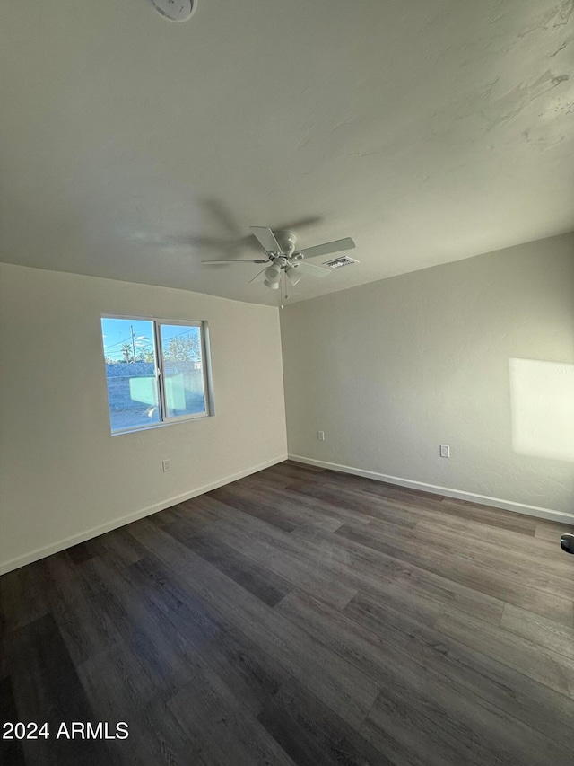 unfurnished room with ceiling fan and dark hardwood / wood-style floors