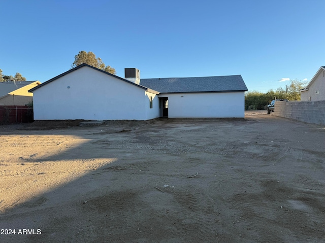 back of house featuring central AC unit