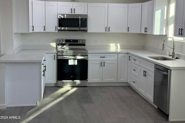 kitchen featuring white cabinetry, appliances with stainless steel finishes, sink, and dark hardwood / wood-style floors