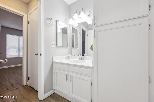 bathroom featuring vanity and hardwood / wood-style floors