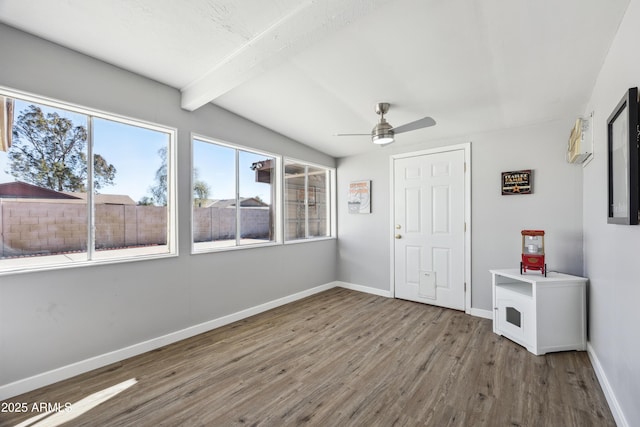 interior space with hardwood / wood-style flooring, plenty of natural light, and beam ceiling