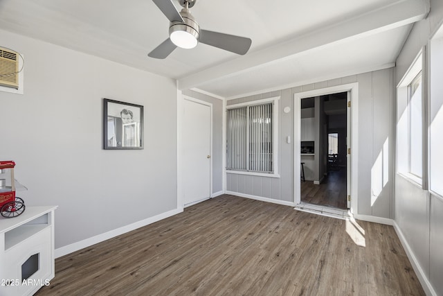 interior space with ceiling fan, beamed ceiling, and a healthy amount of sunlight