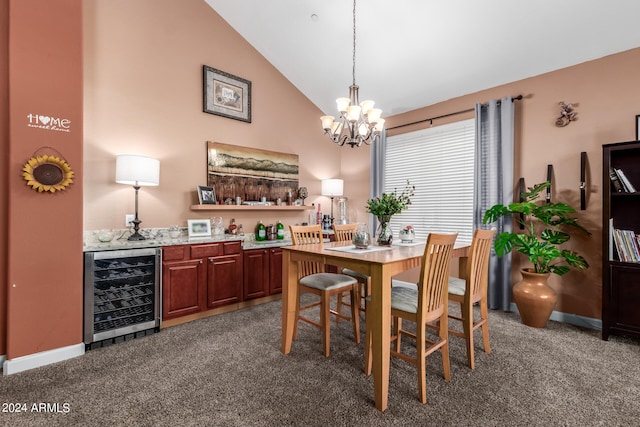 carpeted dining room with bar, a notable chandelier, high vaulted ceiling, and wine cooler