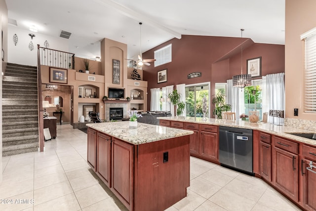 kitchen with dishwasher, a healthy amount of sunlight, light stone countertops, and hanging light fixtures