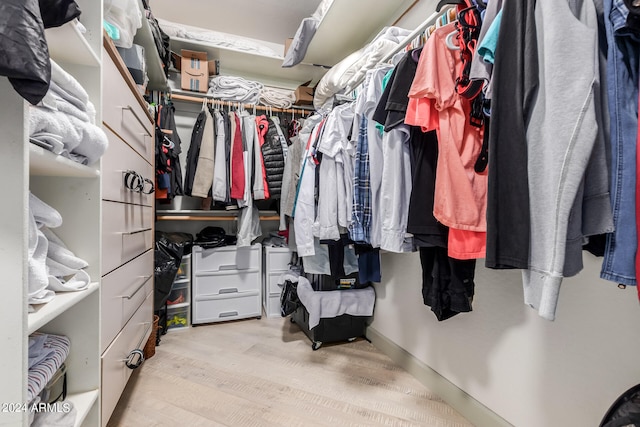 spacious closet with light hardwood / wood-style floors