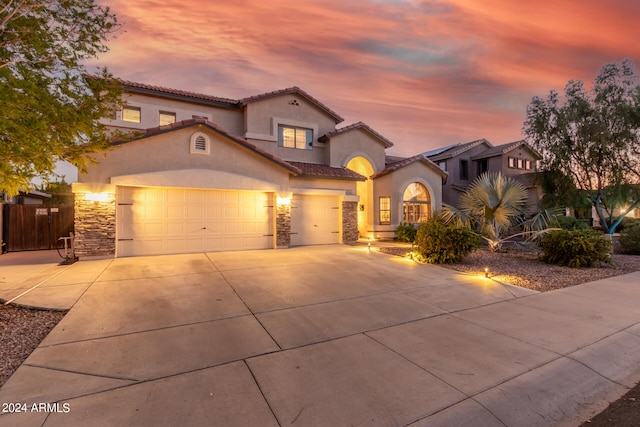 mediterranean / spanish-style home with a garage