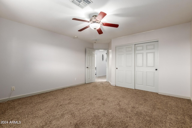 unfurnished bedroom with carpet flooring, ceiling fan, and a closet