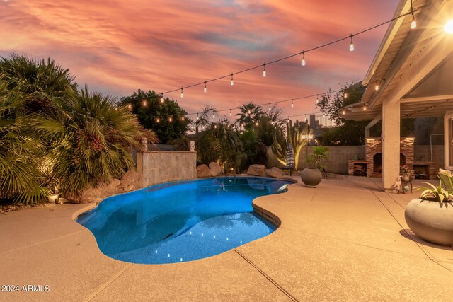 pool at dusk with a patio