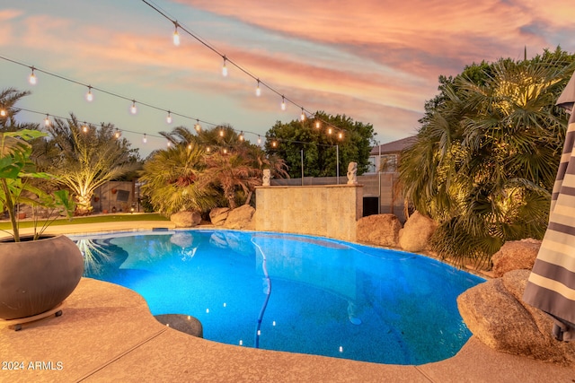 view of pool at dusk