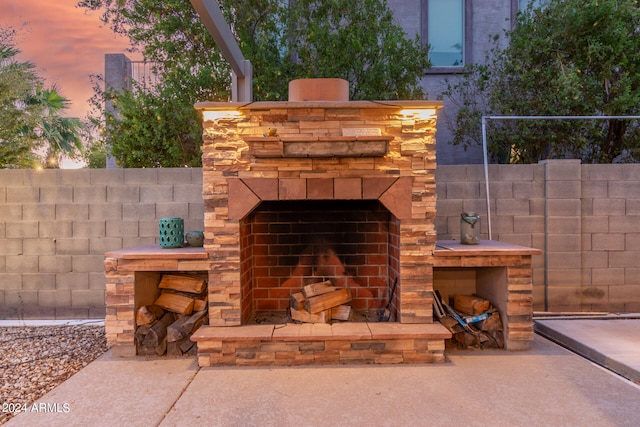 details with an outdoor stone fireplace