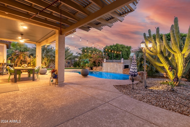 pool at dusk featuring a patio area