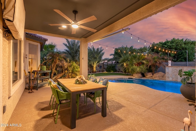 patio terrace at dusk featuring ceiling fan