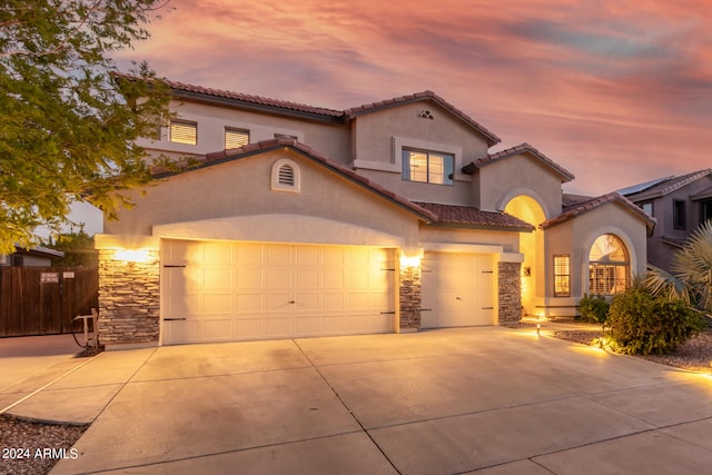 mediterranean / spanish house with a garage