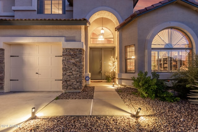 doorway to property with a garage