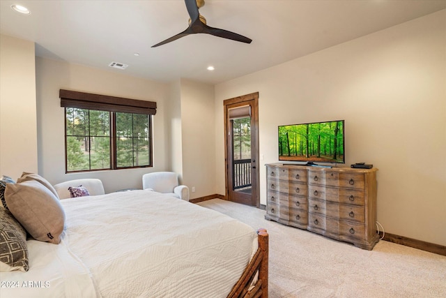 bedroom with light carpet, access to outside, multiple windows, and ceiling fan