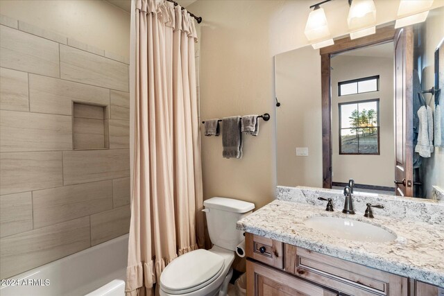 4320 W Arabian Trl, Flagstaff, AZ 86005 - bathroom with toilet, vanity, and shower / bath combo with shower curtain