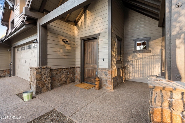4320 W Arabian Trl, Flagstaff, AZ 86005 - doorway to property with stone siding and a garage