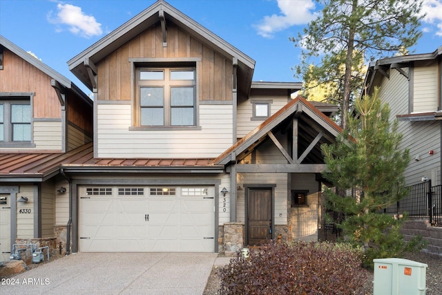 4320 W Arabian Trl, Flagstaff, AZ 86005 - townhome / multi-family property with driveway, an attached garage, stone siding, board and batten siding, and metal roof