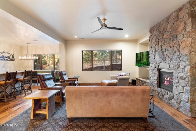 4320 W Arabian Trl, Flagstaff, AZ 86005 - living room featuring wood finished floors, ceiling fan, a stone fireplace, a chandelier, and recessed lighting