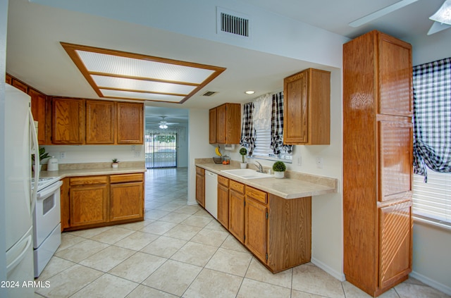 kitchen featuring ceiling fan, sink, light tile patterned floors, and white appliances