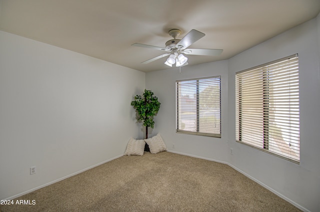 carpeted empty room featuring ceiling fan