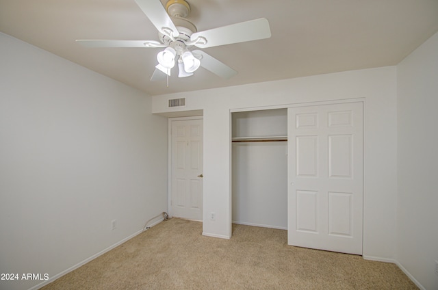 unfurnished bedroom featuring light carpet and ceiling fan