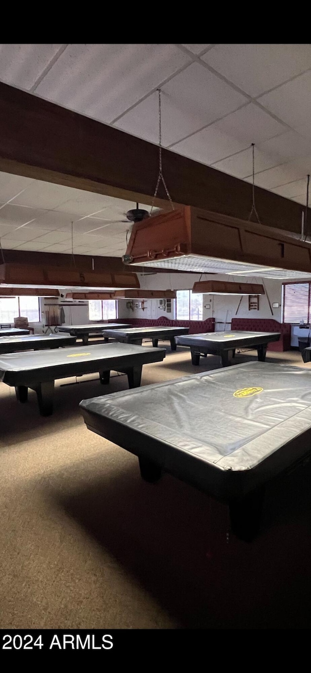 miscellaneous room featuring carpet flooring and beam ceiling