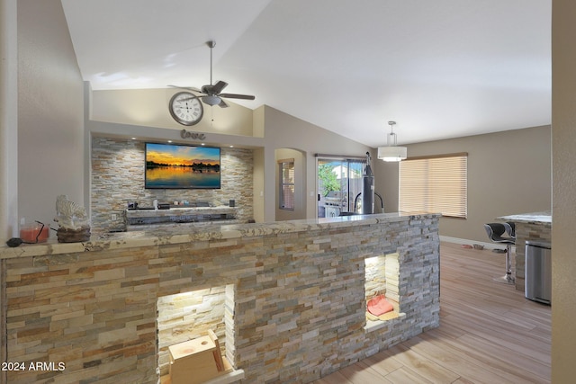 interior space featuring ceiling fan, light hardwood / wood-style floors, decorative light fixtures, and vaulted ceiling