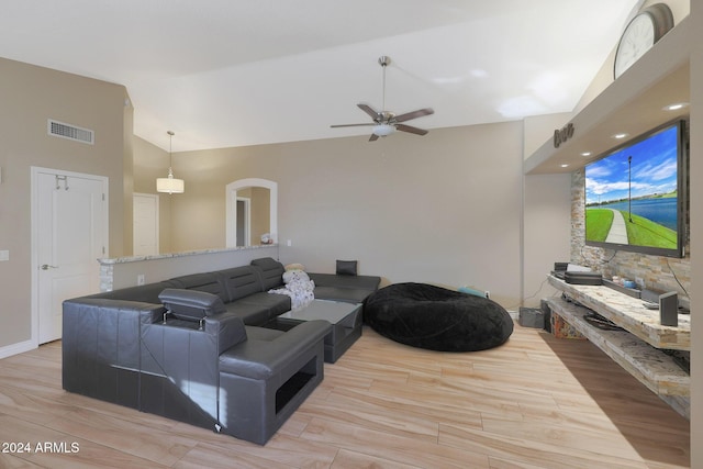 living room featuring high vaulted ceiling, light hardwood / wood-style flooring, and ceiling fan