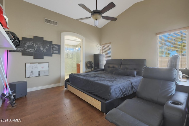 bedroom featuring dark hardwood / wood-style flooring, ensuite bathroom, high vaulted ceiling, and ceiling fan