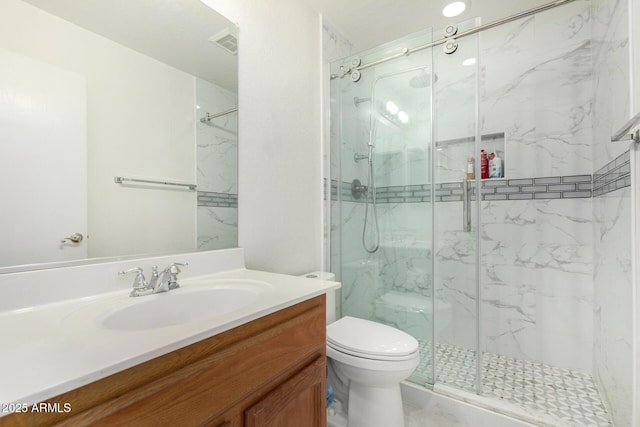 bathroom with vanity, an enclosed shower, and toilet