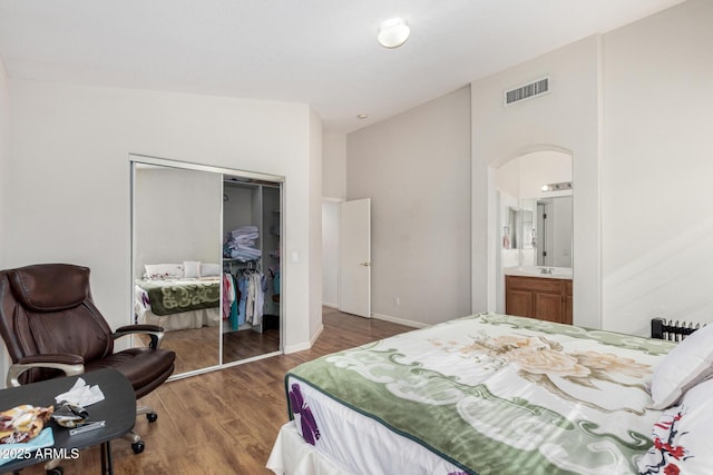 bedroom with hardwood / wood-style flooring and a closet