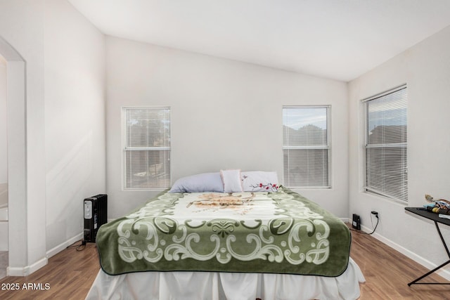 bedroom featuring lofted ceiling and wood-type flooring