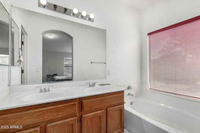 bathroom with vanity and a tub to relax in