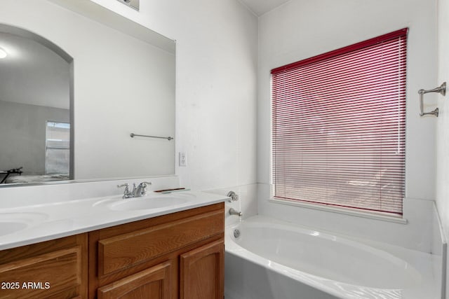 bathroom featuring a tub to relax in and vanity