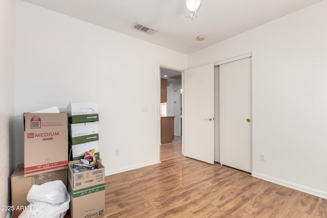 interior space with wood-type flooring and a closet