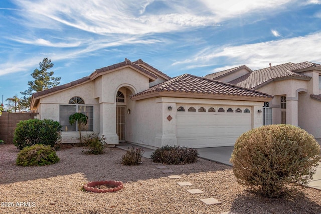 mediterranean / spanish-style home with a garage