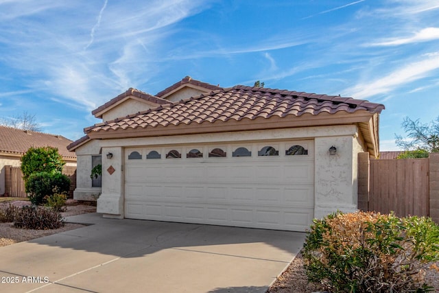 mediterranean / spanish-style house with a garage