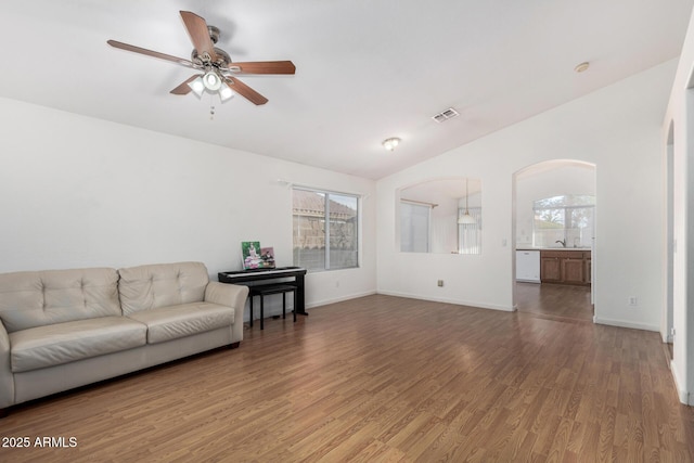 living room with lofted ceiling, hardwood / wood-style floors, and ceiling fan