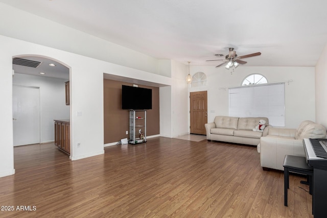 unfurnished living room featuring wood-type flooring and ceiling fan