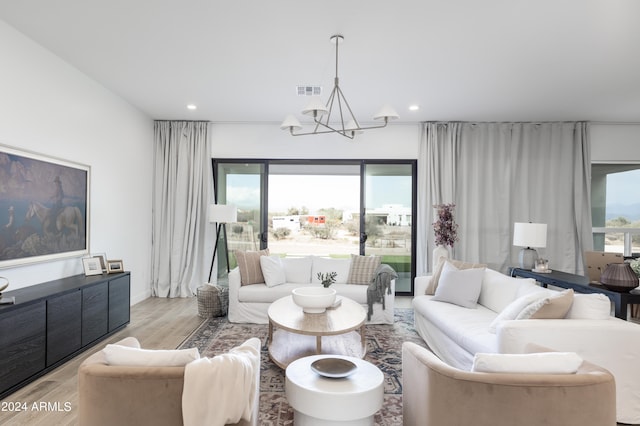 living room featuring light hardwood / wood-style flooring and a notable chandelier