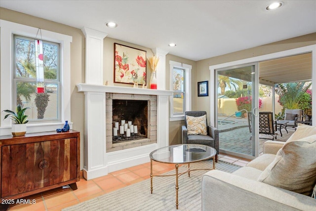 interior space featuring tile patterned flooring, a fireplace, a wealth of natural light, and recessed lighting