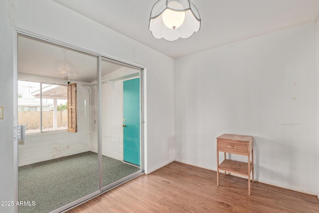 unfurnished room with wood finished floors