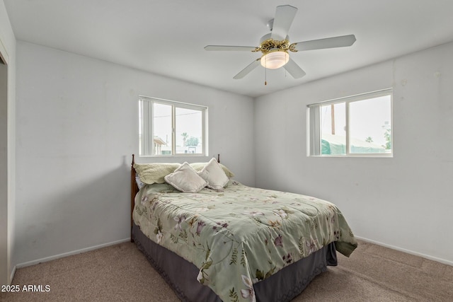 carpeted bedroom featuring baseboards and a ceiling fan