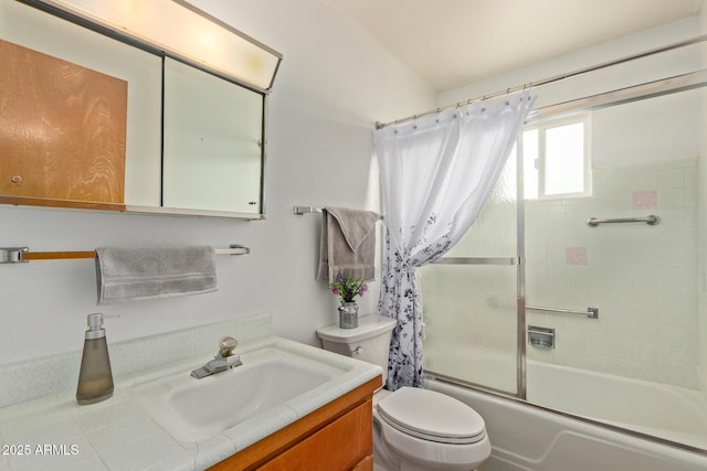 bathroom with toilet, enclosed tub / shower combo, and vanity