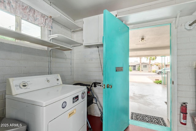 laundry room with washer / dryer and concrete block wall